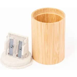 A bamboo cup and a grey pencil sharpener are featured, highlighting natural materials and a simple design.