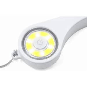 A white circular light with a yellow LED ring, featuring a central button and a tether.