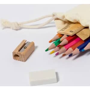 A drawstring bag contains coloured pencils, a wooden sharpener, and an eraser, arranged on a white background.