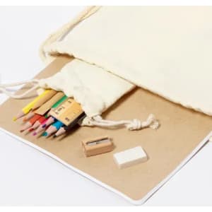 A drawstring pouch contains coloured pencils, a small sharpener, and an eraser, alongside a blank notebook.