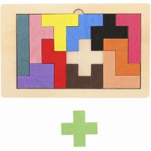 A wooden puzzle featuring various coloured geometric pieces, with a green plus-shaped piece at the bottom.