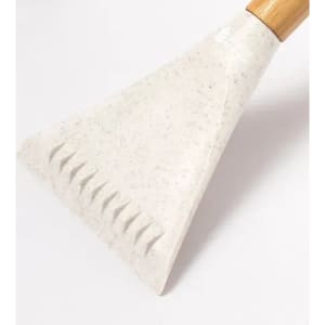 A cooking spatula with a textured edge and a wooden handle, featuring a light grey and speckled design.
