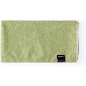 A green RPET cloth with a stitched edge and a small branding tag.