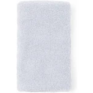 A fluffy light blue towel with a textured surface, featuring a logo at the corner.