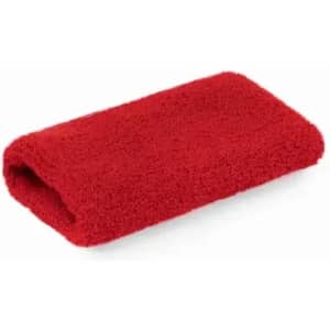 A folded red towel with a fluffy texture, featuring a simple design.