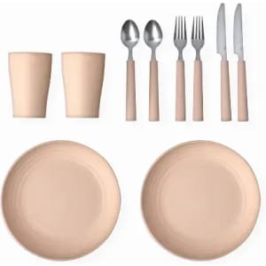 A dining set featuring two beige plates, cups, and metal cutlery with beige handles. It includes forks, knives, and spoons.