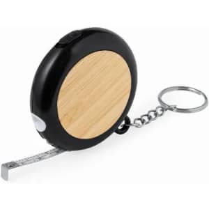 A tape measure with a black and bamboo exterior, featuring a keychain attachment and retractable measuring tape.