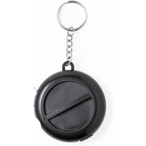 A compact black tape measure with a keychain attachment. Circular design for easy portability.