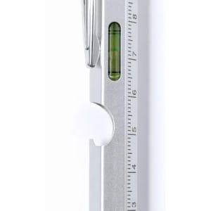 A silver measuring tool with a level indicator and a clip. The markings clearly display measurements up to 6 inches.