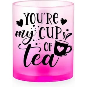 A tea cup candle holder with a pink gradient, featuring a heart and the text "You're my cup of tea."