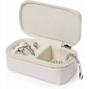 A jewellery box in soft pink with compartments, holding silver rings and a chain. It features a zip closure.