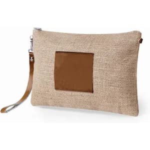 A beige clutch bag made of burlap with a brown leather patch, featuring a wrist strap and zip closure.
