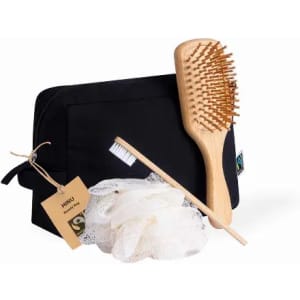A black toiletry bag contains a wooden hairbrush, a natural fibre loofah, and a bamboo toothbrush.