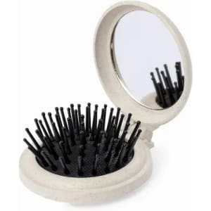 A compact mirror with a brush featuring black bristles, set in a light grey case.