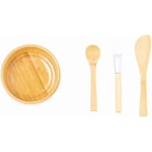 A bamboo dish set featuring a round bowl, a spoon, a spatula, and a spreading knife. All items are natural bamboo.