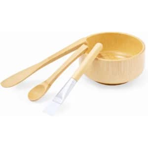 A bamboo bowl set featuring a bowl, a spoon, and a spatula, all in natural wood tones.