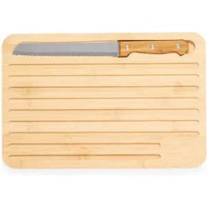 A bamboo cutting board with grooves and a serrated knife with a wooden handle placed on top.