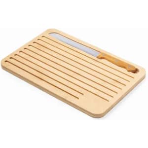 A wooden cutting board with grooves and a stainless steel knife featuring a wooden handle.