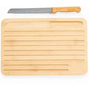 A bamboo cutting board with a serrated knife placed on top. The board features lined grooves for cutting.
