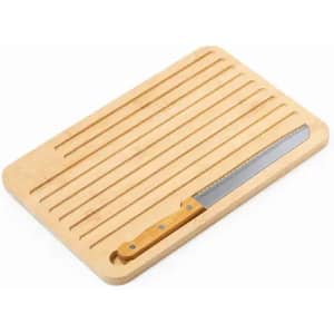 A wooden cutting board featuring grooves and a serrated knife with a wooden handle. The board is light-coloured.