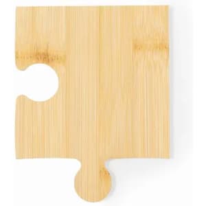 A bamboo puzzle piece coaster in a natural wood finish with a unique cut-out shape.