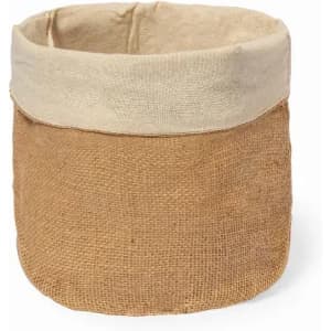 A storage basket made of brown jute with a light beige fabric rim, featuring a simple, rustic design.