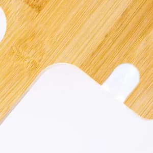 A drink bottle with a sleek white body and a clear cap placed on a wooden surface. It features a logo.