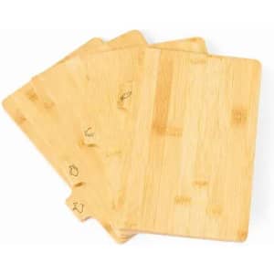 A set of four bamboo chopping boards in a natural wood finish, featuring subtle engraved designs.