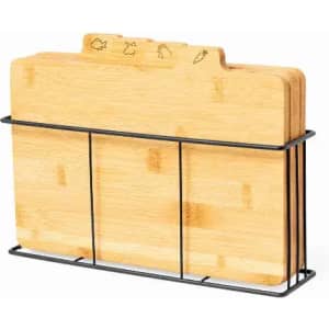 A set of bamboo chopping boards in a black metal holder, featuring engraved designs at the top.