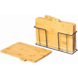 A set of bamboo chopping boards displayed in a black metal holder, featuring various sizes and shapes.