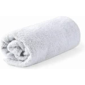 A rolled grey towel made of soft fabric, neatly arranged and showcasing a plush texture.