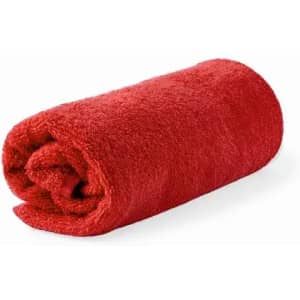A rolled red towel made of plush material, showcasing its soft texture. It has a rounded end.