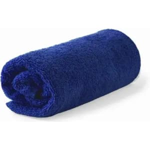 A rolled, fluffy towel in a vibrant navy blue colour, featuring a textured surface. It has a simple, unbranded design.