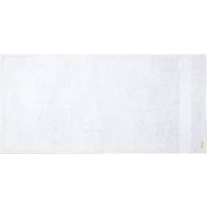 A bath towel in white with a subtle texture and a small logo on one edge.