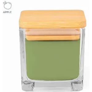 A glass jar with a wooden lid, containing green paint and a light pink interior layer. It features a logo in the corner.