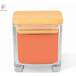 A glass jar with a bamboo lid, containing an orange product. The jar has a square shape and a smooth finish.
