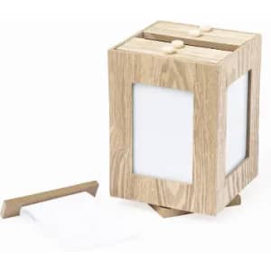 A wooden product holder with a cubic design, featuring two compartments and white paper protruding from one side.