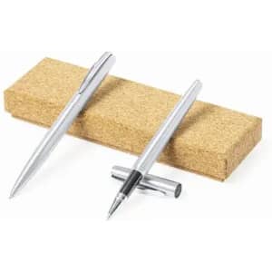 A set of silver pens resting on a cork base, featuring a sleek design with one pen capped.