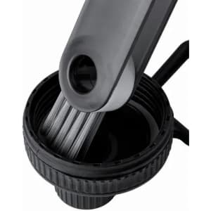 A drink bottle in black and grey with a segmented cap and a brush attachment inside. It has a logo on the side.