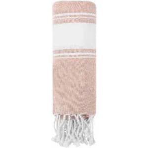 A rolled towel in a soft pink hue, featuring a textured design and white tassels at one end.