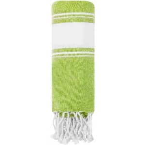 A green towel with a white stripe and fringed edges, neatly rolled up for display.