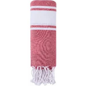A striped red and white towel with fringe detailing at one end, featuring a central white band.