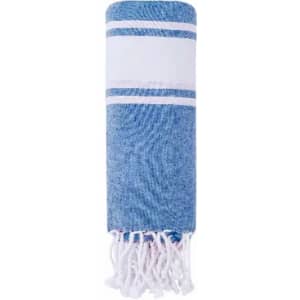 A blue and white striped towel with tassels at the ends, neatly rolled.