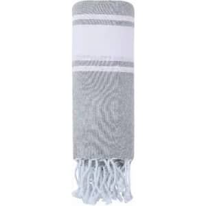 A grey and white striped towel with fringed edges, neatly rolled up. Features a simple, elegant design.