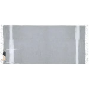 A grey throw with white stripes and tassels along the edges. It includes a tag attached to one end.