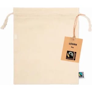 A cream-coloured drawstring bag with a tag, featuring a logo and branding, showcasing Fairtrade certification.