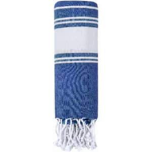 A rolled-up blue and white towel with decorative stripes and fringed edges. It features a simple, classic design.