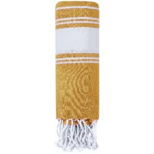 A yellow and white striped towel featuring fringed edges, neatly rolled up.
