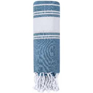 A blue and white striped towel with tassels at one end, featuring a textured design and a folded appearance.