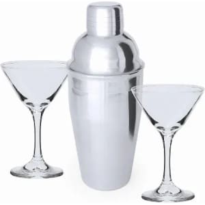 A drink bottle shaker in shiny silver with two clear martini glasses on either side.